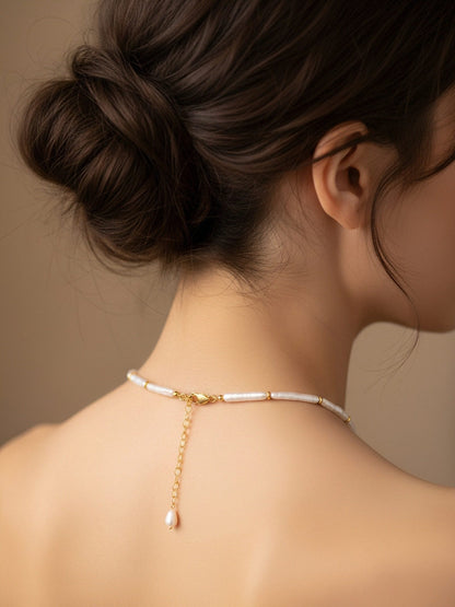 Natural pearl necklace with small silver bar shaped pearl strap and adjustable chain length