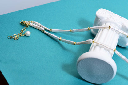 Natural pearl necklace with small silver bar shaped pearl strap and adjustable chain length