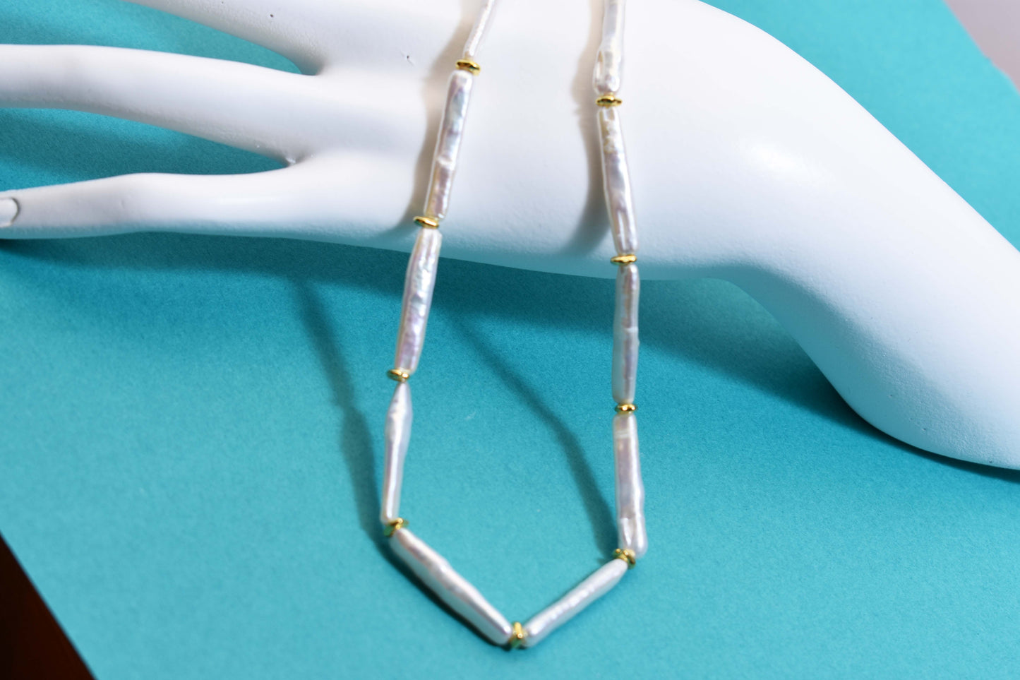 Natural pearl necklace with small silver bar shaped pearl strap and adjustable chain length