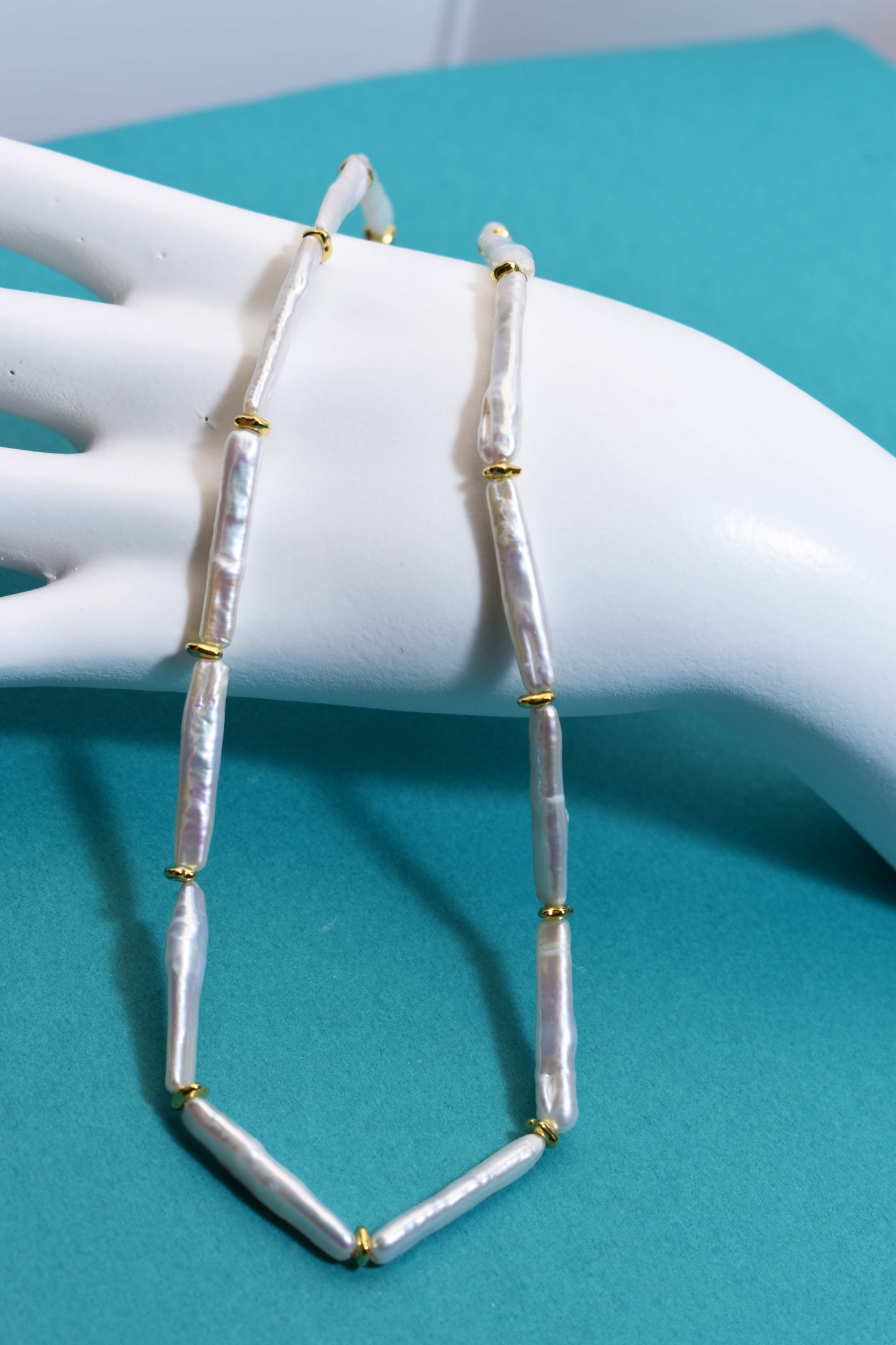 Natural pearl necklace with small silver bar shaped pearl strap and adjustable chain length