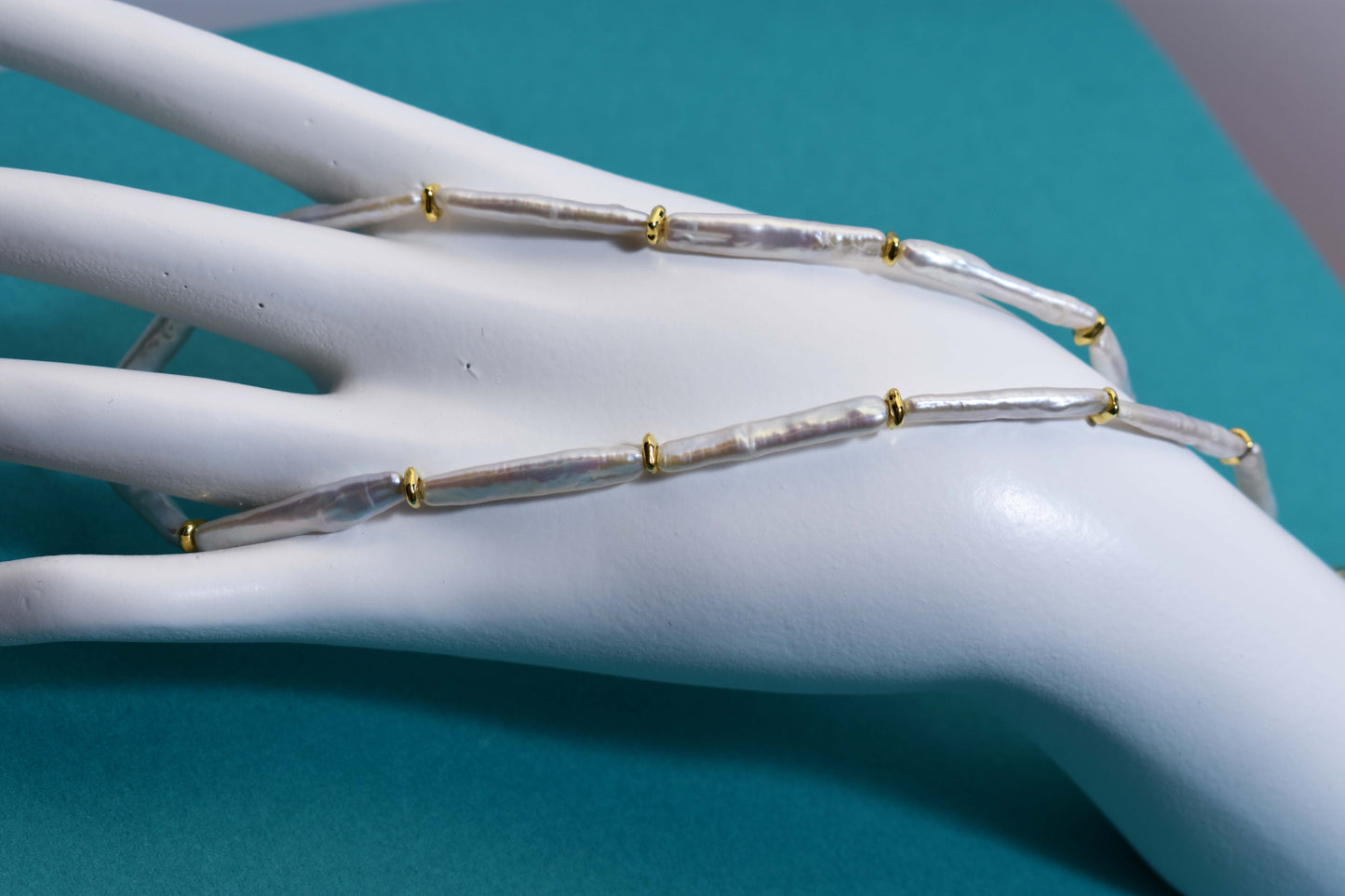 Natural pearl necklace with small silver bar shaped pearl strap and adjustable chain length