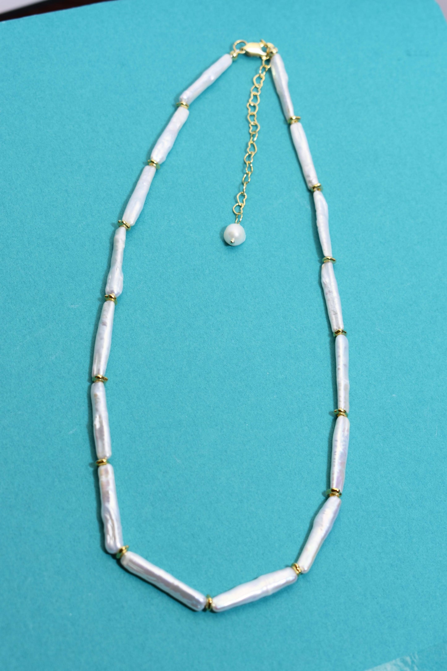 Natural pearl necklace with small silver bar shaped pearl strap and adjustable chain length