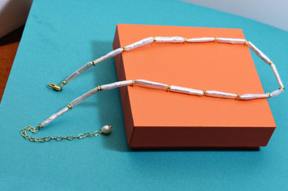 Natural pearl necklace with small silver bar shaped pearl strap and adjustable chain length