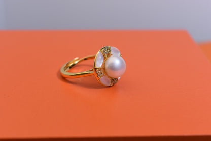 Natural pearl ring with white circular abalone shell surrounding the opening, adjustable ring