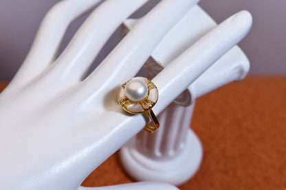 Natural pearl ring with white circular abalone shell surrounding the opening, adjustable ring