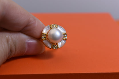 Natural pearl ring with white circular abalone shell surrounding the opening, adjustable ring