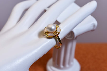 Natural pearl ring with white circular abalone shell surrounding the opening, adjustable ring