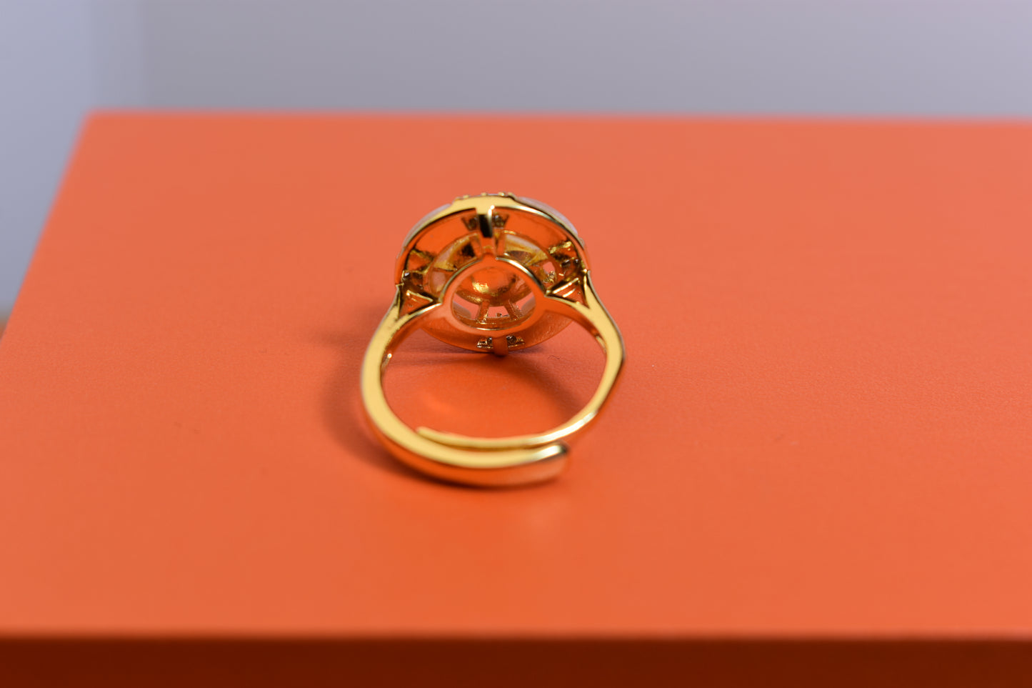 Natural pearl ring with white circular abalone shell surrounding the opening, adjustable ring