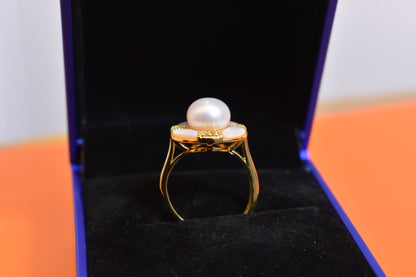 Natural pearl ring with white circular abalone shell surrounding the opening, adjustable ring