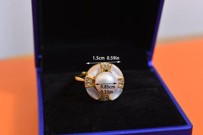 Natural pearl ring with white circular abalone shell surrounding the opening, adjustable ring