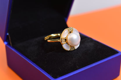Natural pearl ring with white circular abalone shell surrounding the opening, adjustable ring