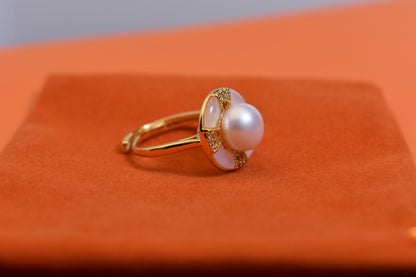 Natural pearl ring with white circular abalone shell surrounding the opening, adjustable ring