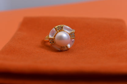 Natural pearl ring with white circular abalone shell surrounding the opening, adjustable ring