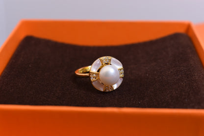 Natural pearl ring with white circular abalone shell surrounding the opening, adjustable ring