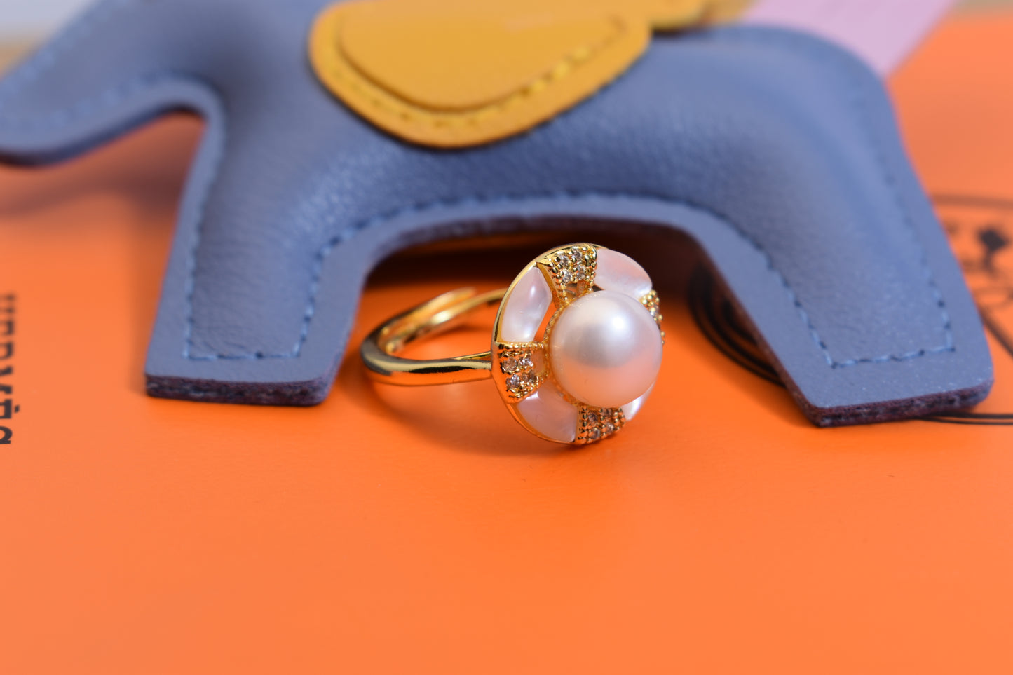 Natural pearl ring with white circular abalone shell surrounding the opening, adjustable ring