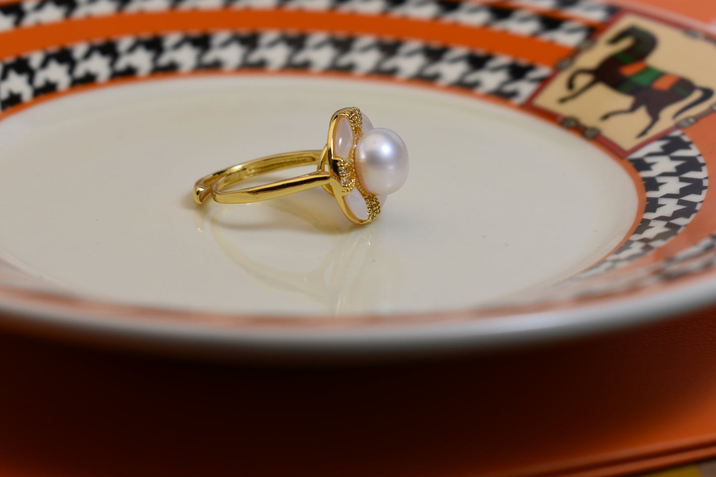 Natural pearl ring with white circular abalone shell surrounding the opening, adjustable ring