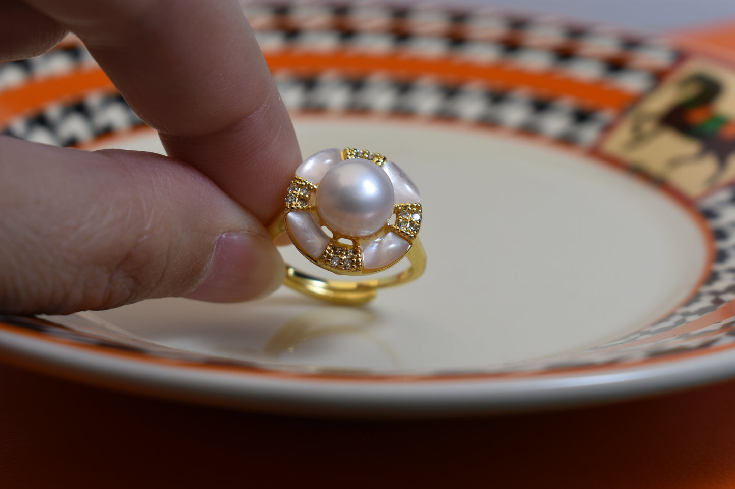 Natural pearl ring with white circular abalone shell surrounding the opening, adjustable ring